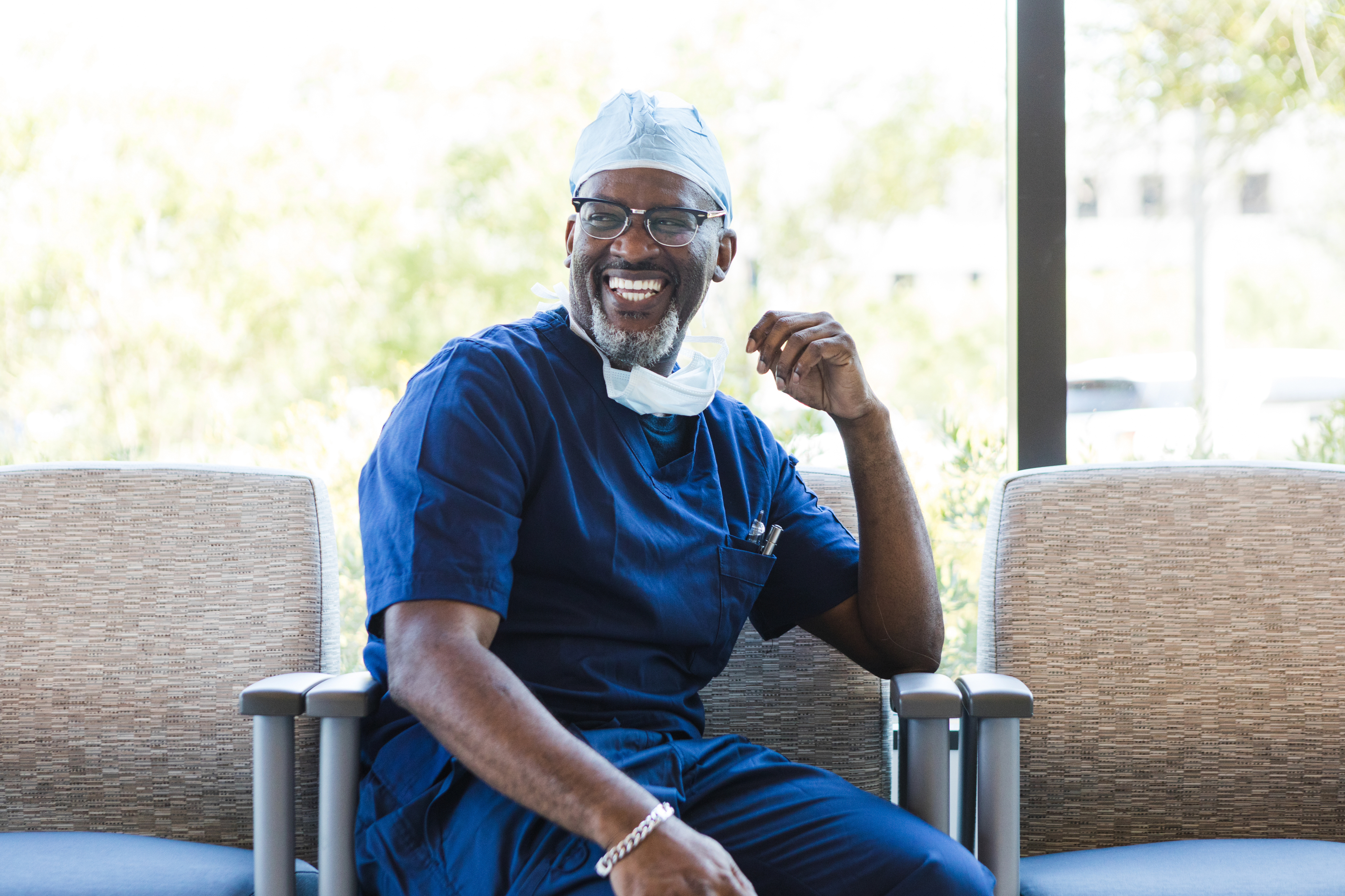Doctor smiles as he hears coworkers having a good time